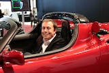 Elon Musk sits in the Tesla Roadster electric vehicle in 2009.