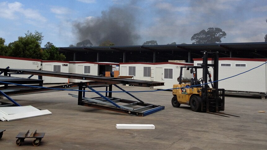 Black smoke rises from a fire at an industrial site at Narangba on September 25, 2012.