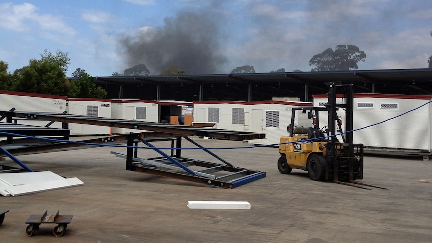 Black smoke rises from a fire at an industrial site at Narangba on September 25, 2012.