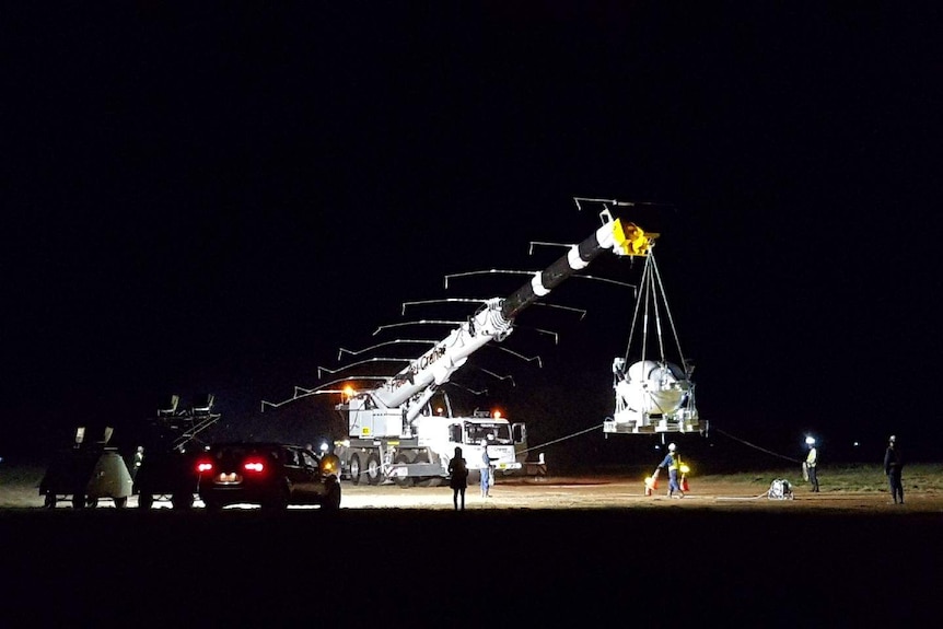 A space balloon being lifted from a crane in Alice Springs.