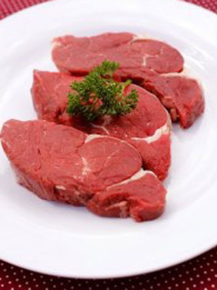 Three steaks on a white plate.