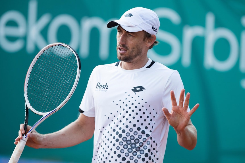 John Millman holds up his hands 