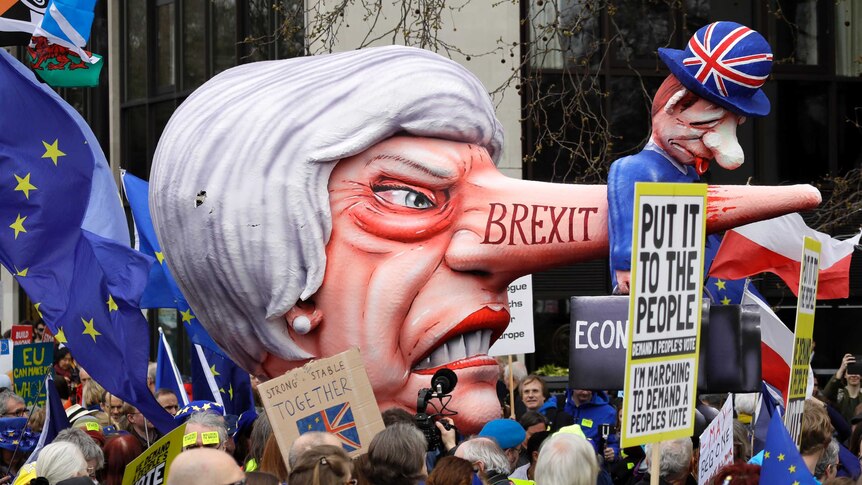 A blow-up effigy of British Prime Minister Theresa May is paraded during a protest in London.