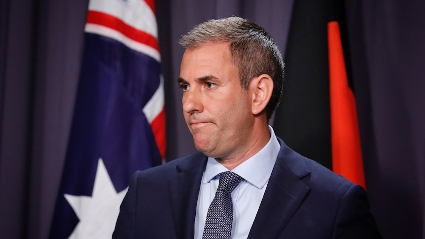 Jim Chalmers with a serious expression on his face at a press conference at Parliament House