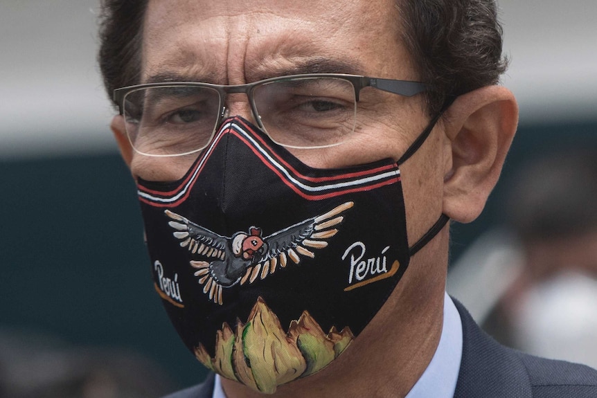 Peruvian President Martín Vizcarra wearing a mask saying 'Peru'.