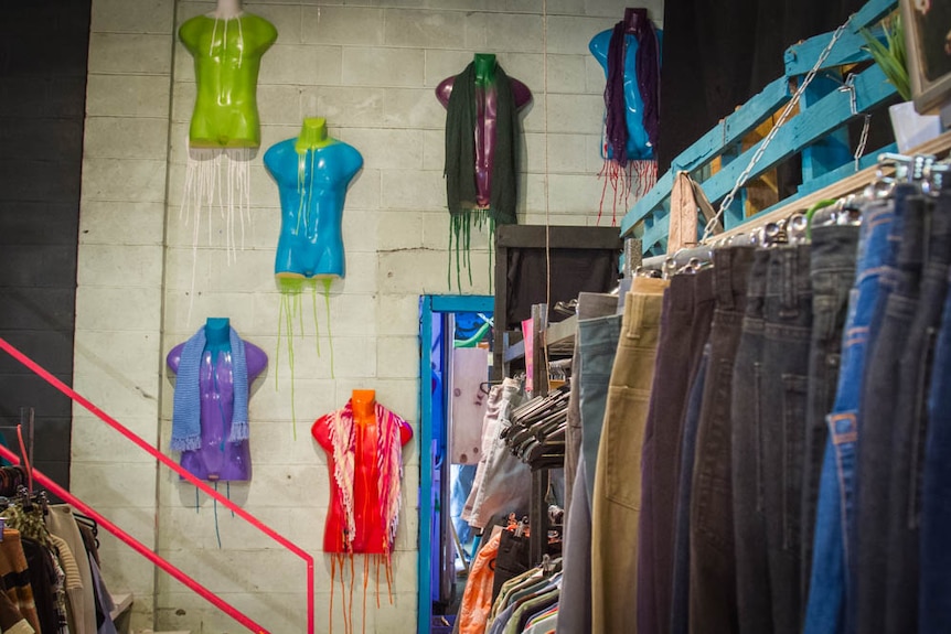 Jeans on a rack inside the store.