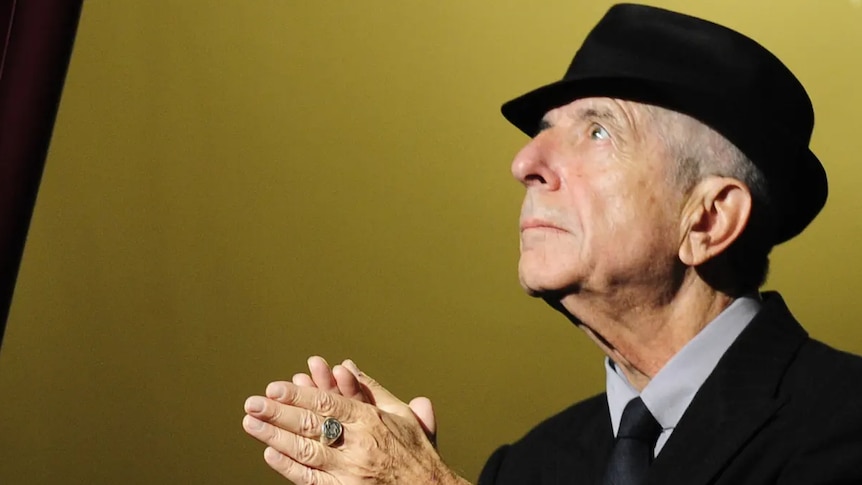 Leonard Cohen clasps his hands in gratitude