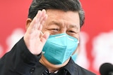 Chinese President Xi Jinping wears a medical mask as he waves during what looks like a press event