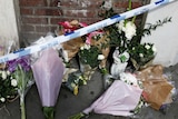 Flowers and messages lie behind police cordon tape near Borough Market after an attack left seven people dead in London.