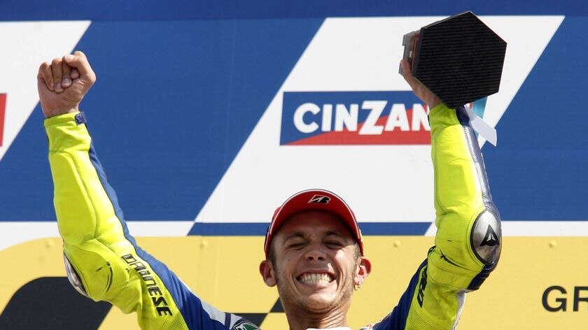 Valentino Rossi celebrates on the podium after winning the San Marino Grand Prix