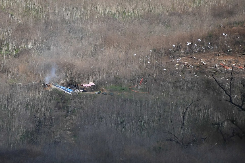 Debris and smoke after the helicopter crash that killed nine people