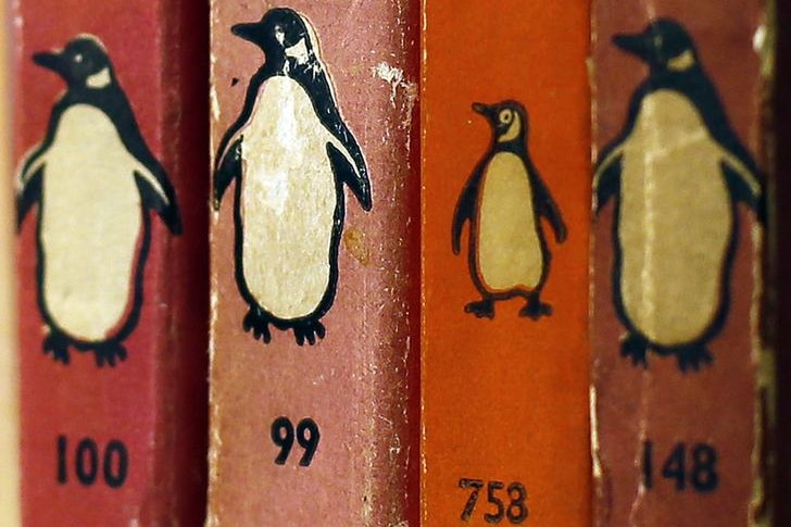 A close-up of four orange Penguin paperback book spines sitting on a bookshelf.