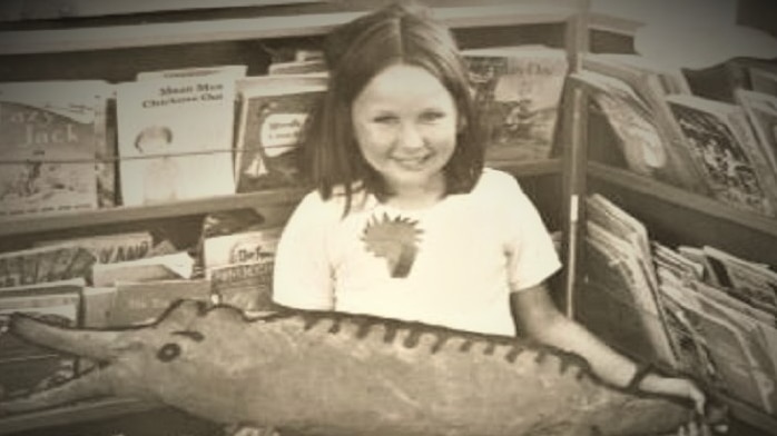 A young Debby Daniels poses with a cut-out fish drawing.