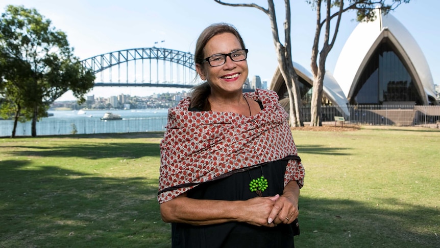 Rhoda Roberts stands in front of the Opera House and Harbour Bridge in Sydney