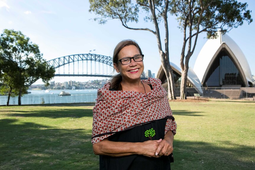 Rhoda Roberts stands in front of the Opera House and Harbour Bridge in Sydney
