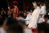 pope francis reads from a text at a service 