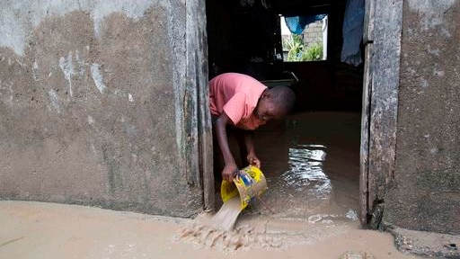 A boy removes mud and water from his house after Hurricane Matthew flooded it in Les Cayes, Haiti.