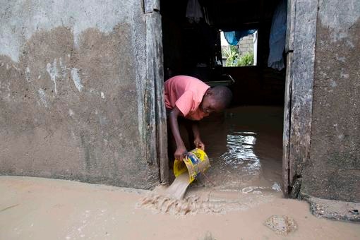 A boy removes mud and water from his house after Hurricane Matthew flooded it in Les Cayes, Haiti.
