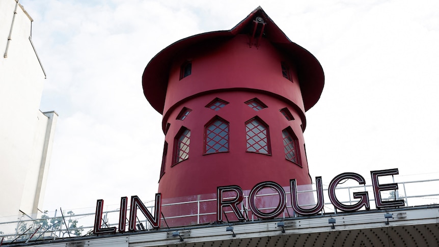 The Moulin Rouge sign missing some letters with the windmill sails missing.