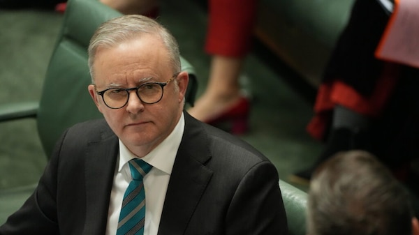 A man in glasses wearing a tie.