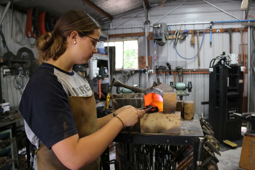 Leila Haddad making a knife at her blacksmith forge in Tharwa.