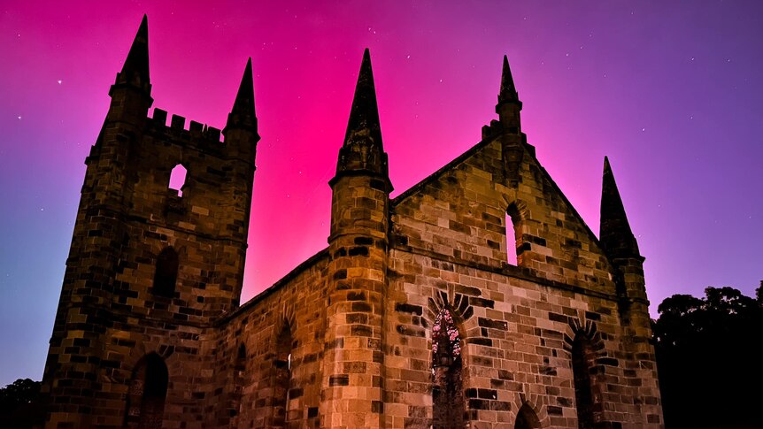 An old church at Port Arthur photographed in front of a pink and blue sky