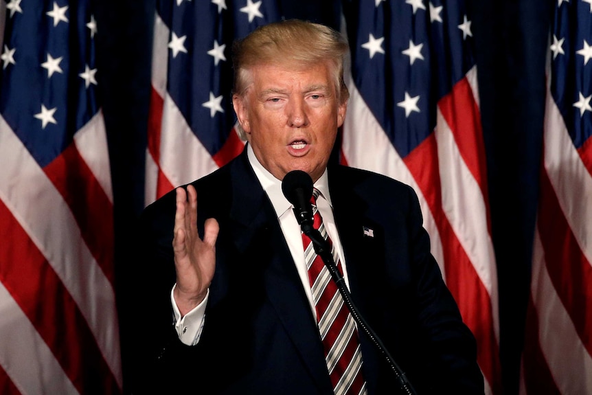 Donald Trump speaks at a lectern in Philadelphia.