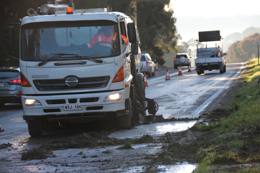 A streetsweeper cleans up milk on the South Eastern Freeway