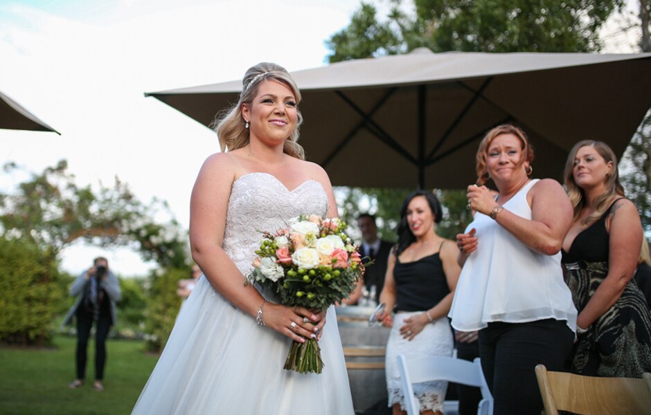 Amanda walks down the aisle in a white wedding dress