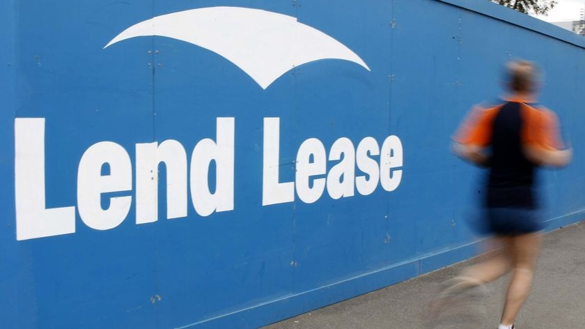 A jogger runs past a Lend Lease sign