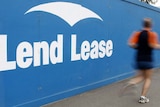 A jogger runs past a Lend Lease sign