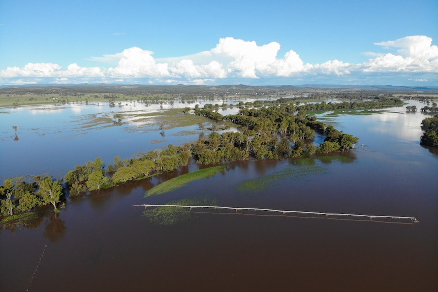 A drone shot of farmland under floodwaters.