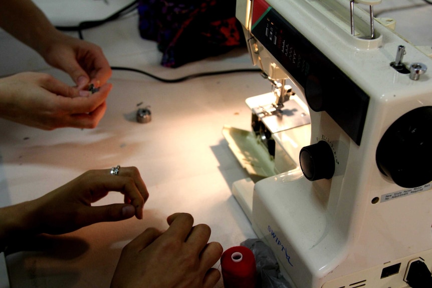 Hands in front of a sewing machine