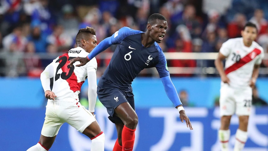Paul Pogba moves past a Peru player with the ball