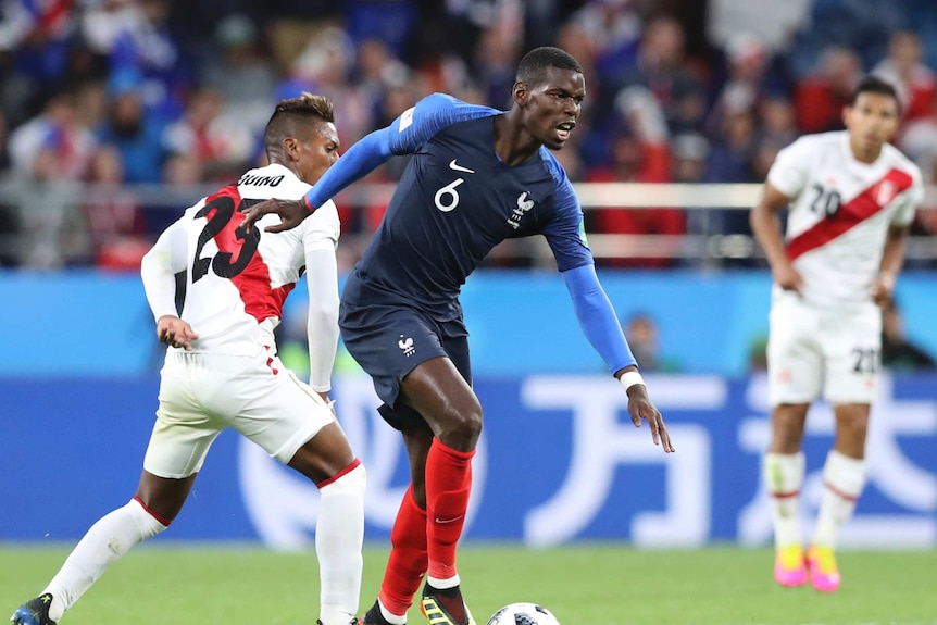 Paul Pogba moves past a Peru player with the ball