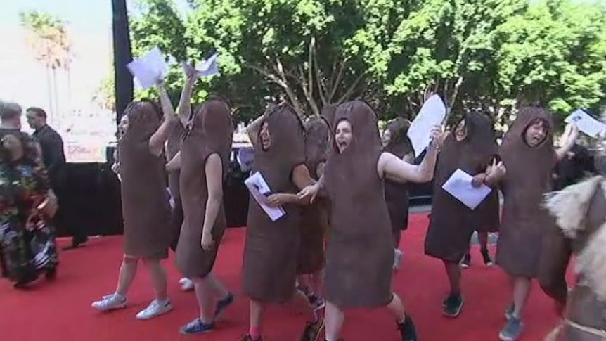 Protesters enter red carpet chanting: "End the sausage party".