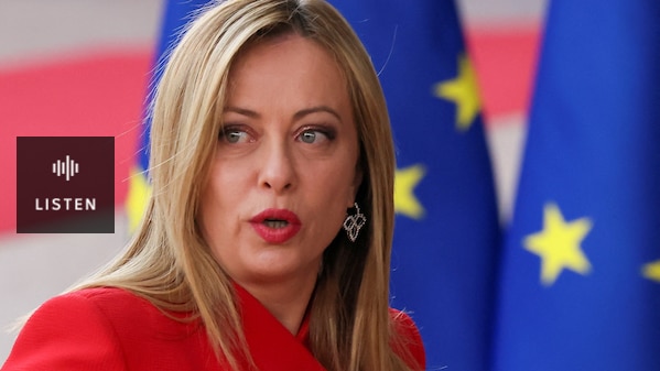 a closeup of Meloni's face as she stands in front of EU flags. Has Audio.