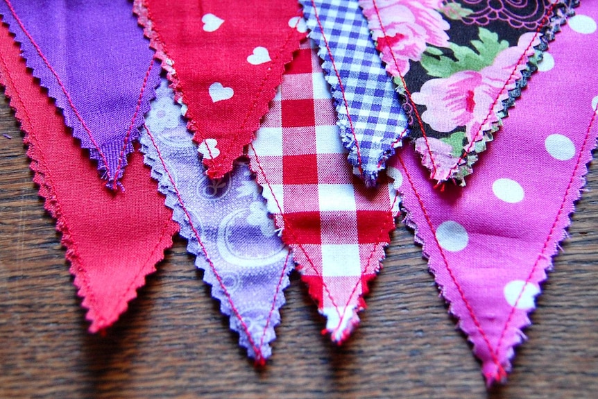 Cloth bunting in red, pink, purple and blue patterns