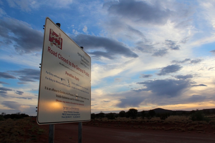 The sign on the Northern Territory - South Australia border marking the entrance to the APY Lands.