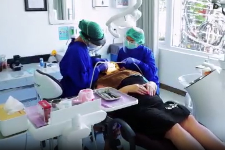 Generic of a dentist working on someone's teeth from a promotional video of a dental clinic in Bali.