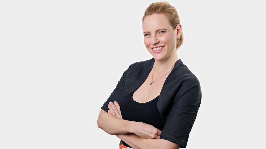 Woman smiling at camera with her arms folded