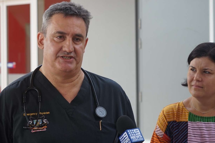 Dr Didier Palmer in scrubs talks outside Royal Darwin Hospital at a press conference