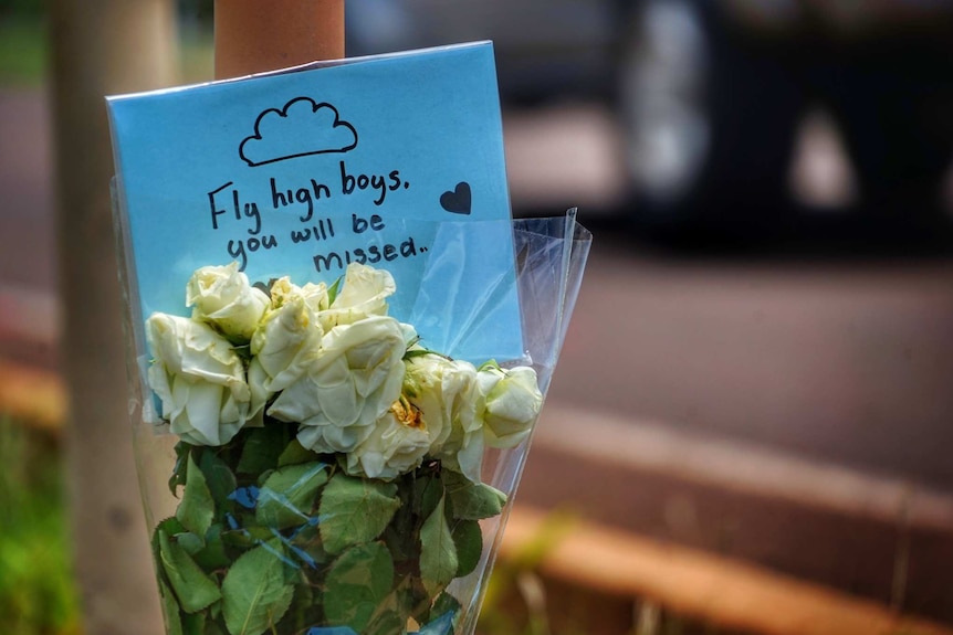 A floral tribute with the inscription 'fly high boys, you will be missed' to two boys killed by a car.