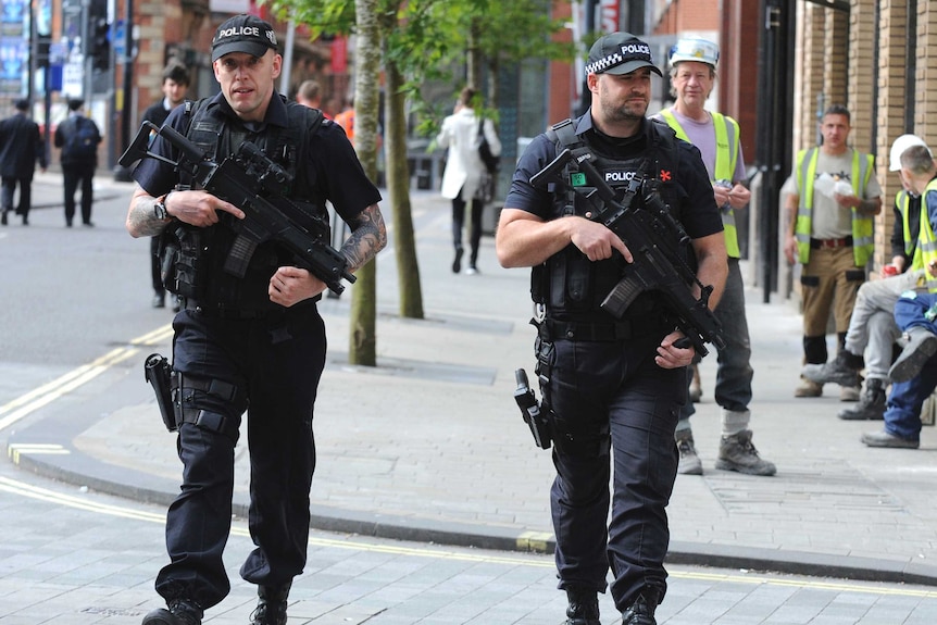 Armed police patrol the streets near to Manchester Arena