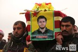 Kurdish fighters carry coffin