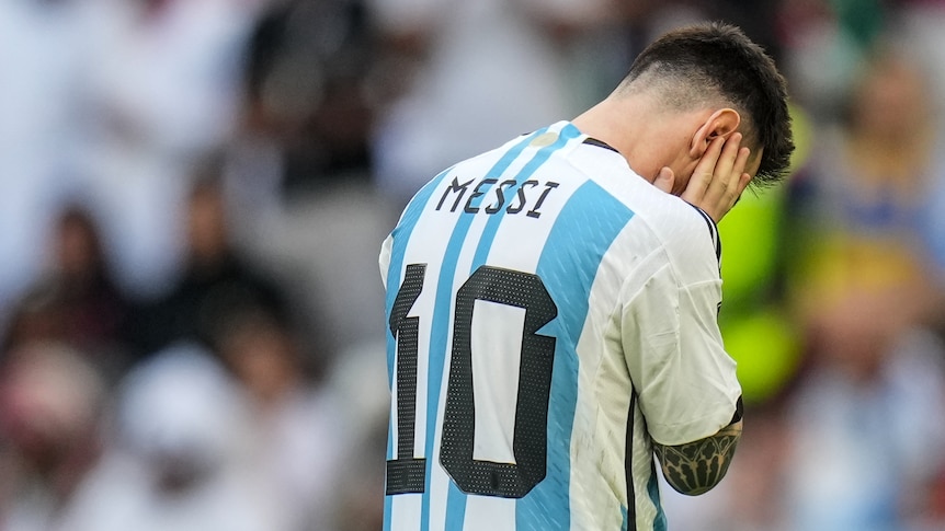 Lionel Messi holds his head in his hands