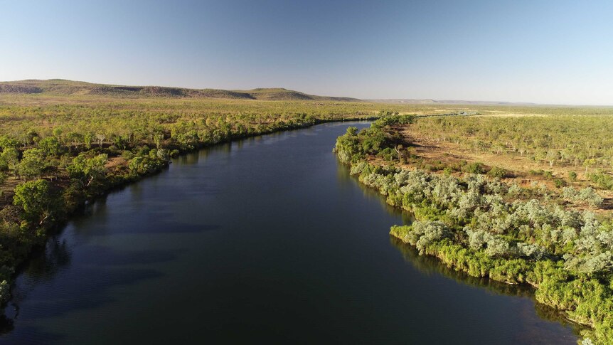A view of the wide  King Edward River near Kalumburu surrounded by bush and low hills