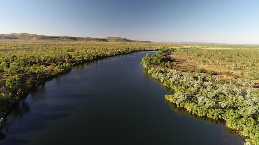 A view of the wide  King Edward River near Kalumburu surrounded by bush and low hills