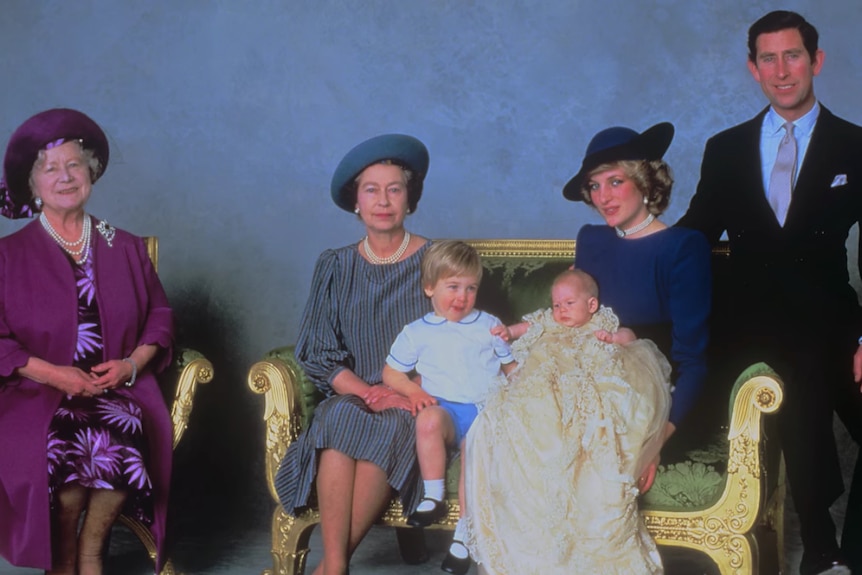 Ritratto della famiglia reale seduta davanti a uno sfondo blu 