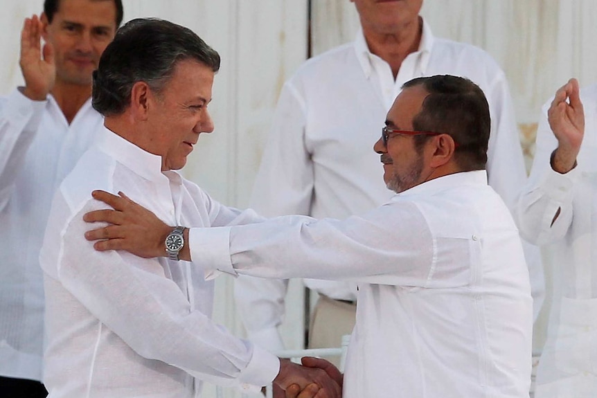 Juan Manuel Santos and Marxist rebel leader Timochenko